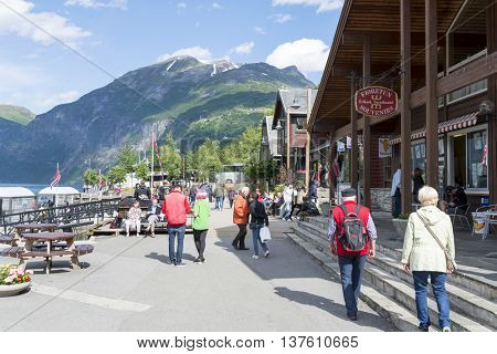 GERANGER, NORWAY - JUNE 29: Tourists enjoying the beautiful weather walking through the streets of Geiranger on June 29, 2016 in Geiranger, Norway. Geiranger is UNESCO heritage site.