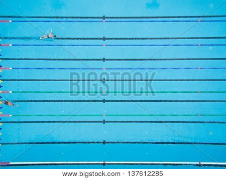 Captured top view of swimming pool and 2 swimmer