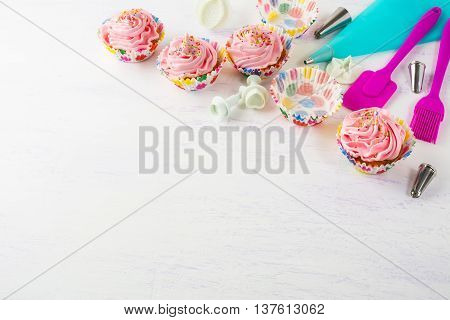 Pink cupcakes and cookware invitation background. Birthday cupcakes. Birthday background. Homemade cupcake. Birthday mockup.