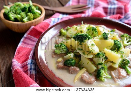 Pork with broccoli, ginger root and boiled potatoes