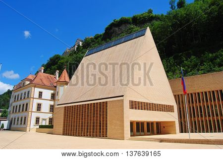 Vaduz, Liechtenstein - July 14, 2014. The Parliament building in Vaduz, with surrounding buildings, in summer.