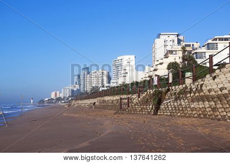 Early Morning Empty Beach And Concrete Retaining Wall