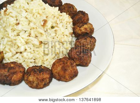 traditional greek rice pilaff with baked meatballs