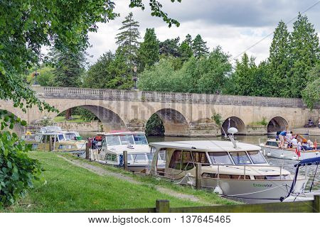Wallingford/UK. 3rd July 2016. The River Thames at Wallingford with boats moored up by the bridge.