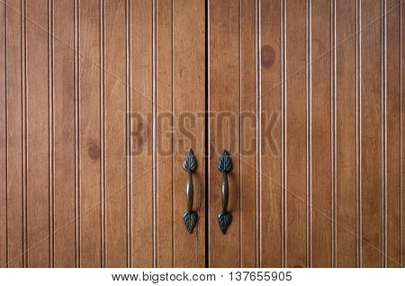 Close up of wooden doors on an armoire.