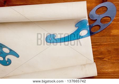Roll of paper for drawings on a wooden table