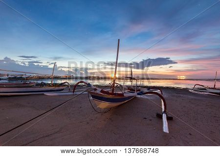 Holiday in Bali, Indonesia - Reflection Sunrise in Tanjong Benoa with boat