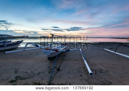 Holiday in Bali, Indonesia - Reflection Sunrise in Tanjong Benoa with boat