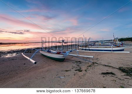 Holiday in Bali, Indonesia - Reflection Sunrise in Tanjong Benoa with boat