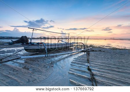 Holiday in Bali, Indonesia - Reflection Sunrise in Tanjong Benoa with boat
