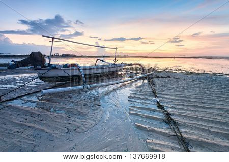 Holiday in Bali, Indonesia - Reflection Sunrise in Tanjong Benoa with boat