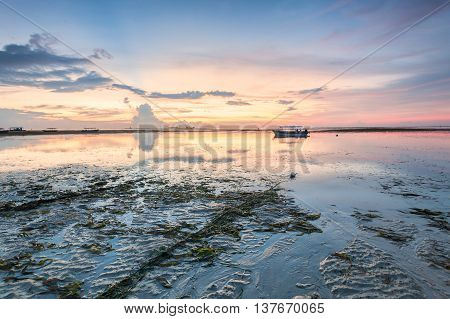 Holiday in Bali, Indonesia - Reflection Sunrise in Tanjong Benoa with boat