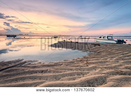 Holiday in Bali, Indonesia - Reflection Sunrise in Tanjong Benoa with boat