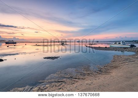 Holiday in Bali, Indonesia - Reflection Sunrise in Tanjong Benoa with boat