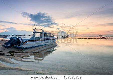 Holiday in Bali, Indonesia - Reflection Sunrise in Tanjong Benoa with boat