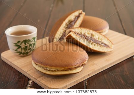 Japanese Dessert Dorayaki And Tea On Wood Board