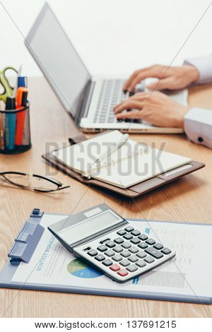 Close up of accountant or banker making calculations. Savings finances and economy concept