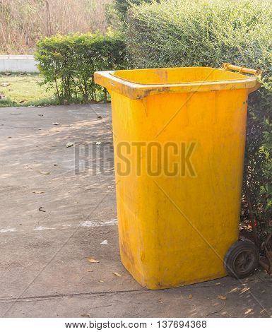 yellow dustbins trashcan rubbish bins in the garden.