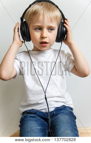 Happy Cheerful Boy With Headphones Listening To Music,