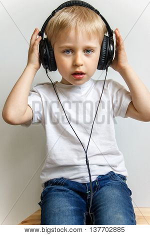 Happy Cheerful Boy With Headphones Listening To Music