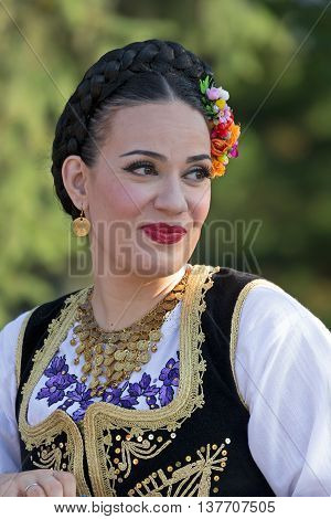 ROMANIA TIMISOARA - JULY 7 2016: Young woman from Romania in traditional costume present at the international folk festival " International Festival of hearts " organized by the City Hall Timisoara.