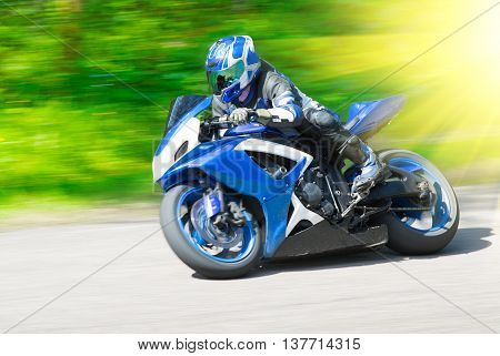 Dynamic and realistic motorbike racing on bright summer background