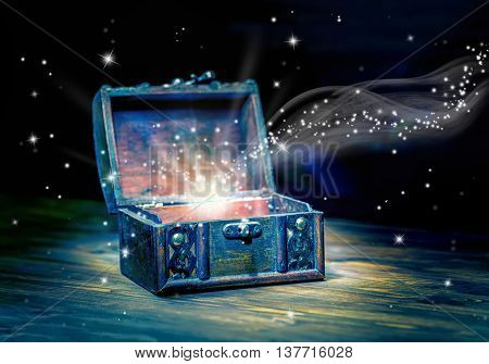 Concept Greeting Card Of Opened Chest Treasure With Mystical Miracle Light On Wooden Background, Bea