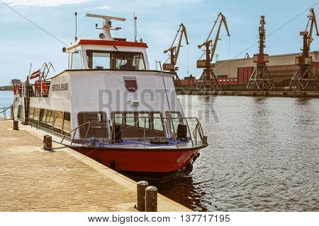 Ventspils Latvia - May 8 2016: Excursion Ferry docked on the Venta River in Ventspils Latvia. Ventspils a city in the Courland region of Latvia. Latvia is one of the Baltic countries