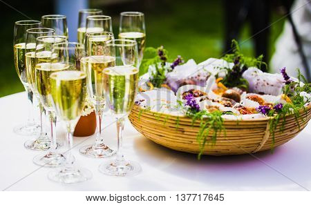champagne glass with canape outside in garden party