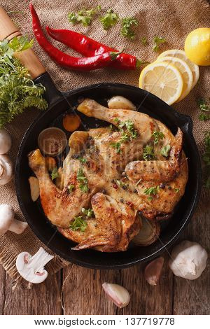 Hot Fried Chicken Tabaka With Ingredients Close-up. Vertical Top View
