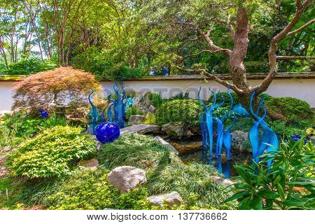 ATLANTA GA USA - APRIL 23 2016: Exhibition of glass artist Chihuly takes place in the Atlanta Botanical Garden in Atlanta Georgia in 2016.