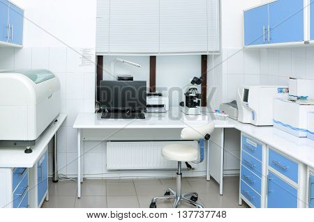 Laboratory room with medical equipment to conduct medical tests and chemical analysis