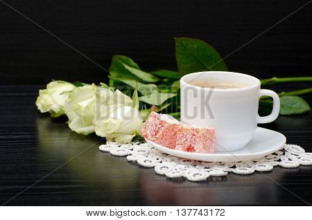 Coffee with milk Turkish Delight bouquet of white roses on a black background