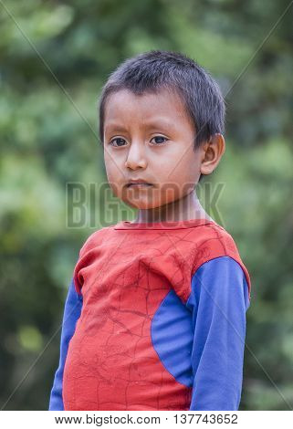 PUYO, ECUADOR, OCTOBER - 2015 - Portrait of amazonic indigenous ecuadorian kid with serious expression in Puyo Ecuador.