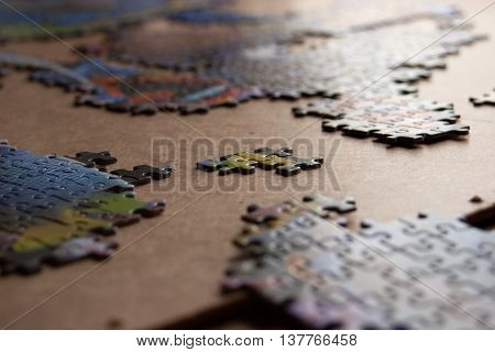Partially completed color puzzle on table closeup