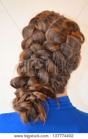 Weaving with long hair - young girl in blue on a white background