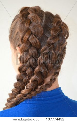 Weaving with long hair - young girl in blue on a white background
