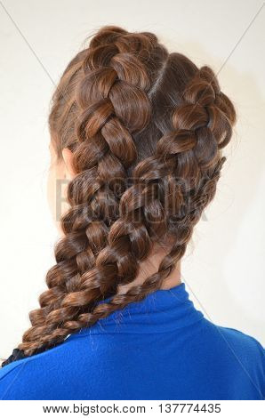 Weaving with long hair - young girl in blue on a white background