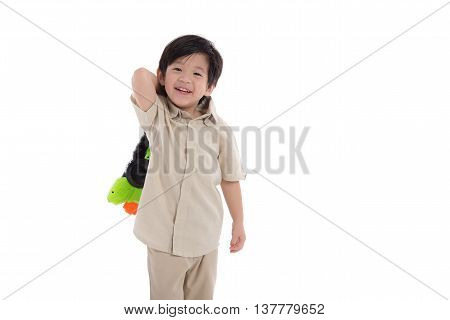 Cute asian boy playing toy gun on white background isolated