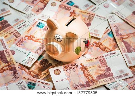 Piggy Bank In A Pile Of Russian Five Thousand Banknotes