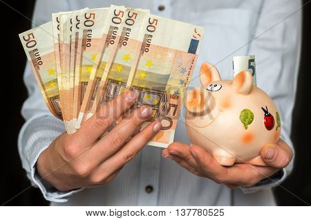 Young Woman With Piggy Bank And Euro Money Banknotes