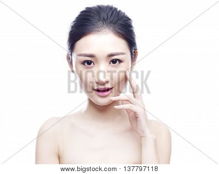 studio portrait of a young and beautiful asian woman hand on chin looking at camera isolated on white background.