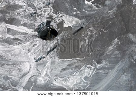 the spotty textured and indistinct abstract gray background with a hole