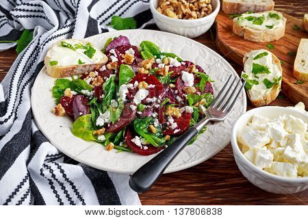 Healthy Beet Salad with fresh sweet baby spinach, kale lettuce, nuts, feta cheese and toast with melted cheese.
