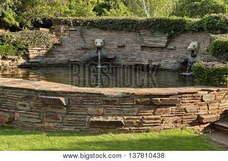 Fountain with mammal head statue in Johannesburg Botanical Garden, South Africa