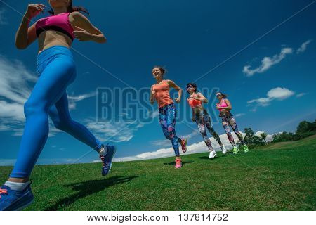 Morning running. Running athletes. Group of female runners on scamper.