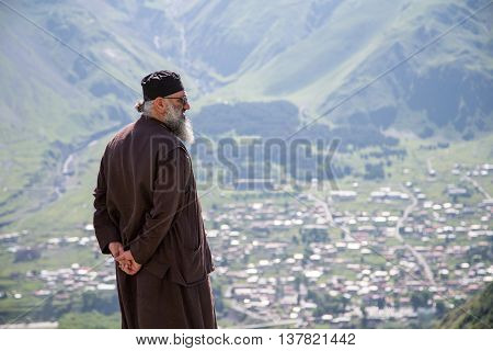 KAZBEGI GEORGIA - CIRCA JULY 2016:a father in the church yard