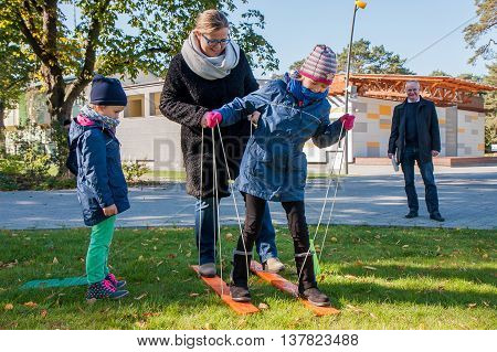 Jozefow Poland - October 10 2015: Parents with children playing various games on the grass in the park in city center