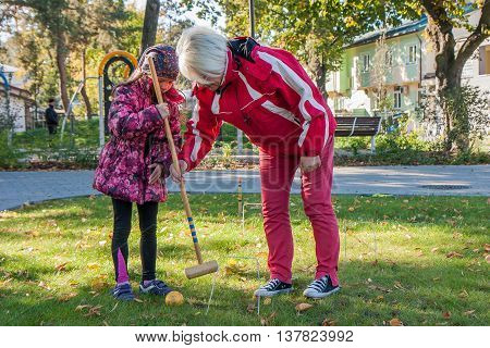 Jozefow Poland - October 10 2015: Parents with children playing various games on the grass in the park in city center