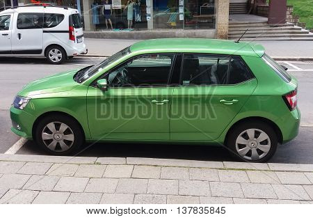 PRAGUE CZECH REPUBLIC - CIRCA JUNE 2016: light green Skoda Fabia car parked on a street of the city centre